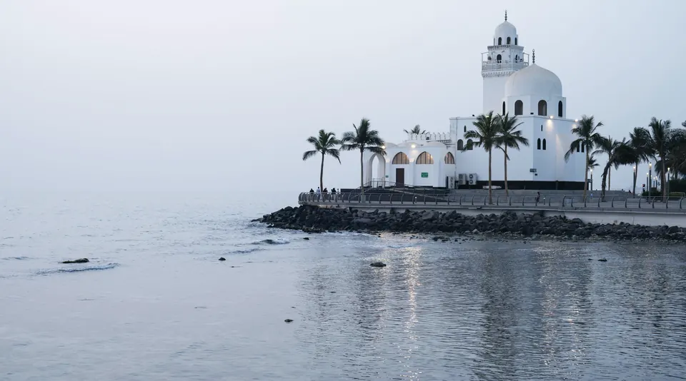 The white Al Rahmah mosque on the Jeddah Corniche above the calm Red Sea